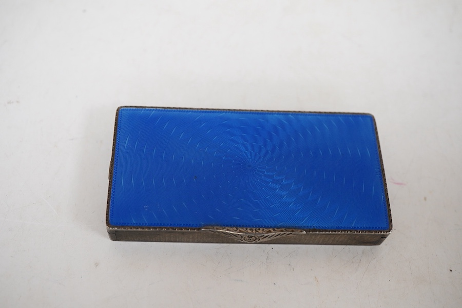 An early to mid 20th century engine turned silver and blue guilloche enamelled rectangular compact (a.f.), London import marks, 79mm.